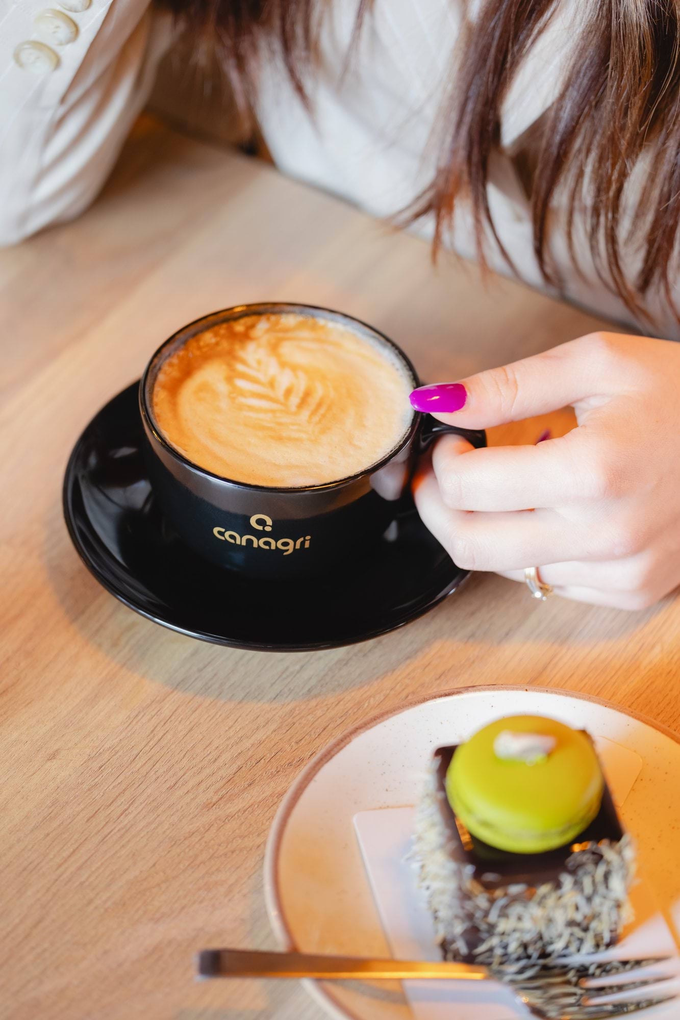 A black cup with a golden Canagri logo, ceramic, glossy finish, 220 ml.